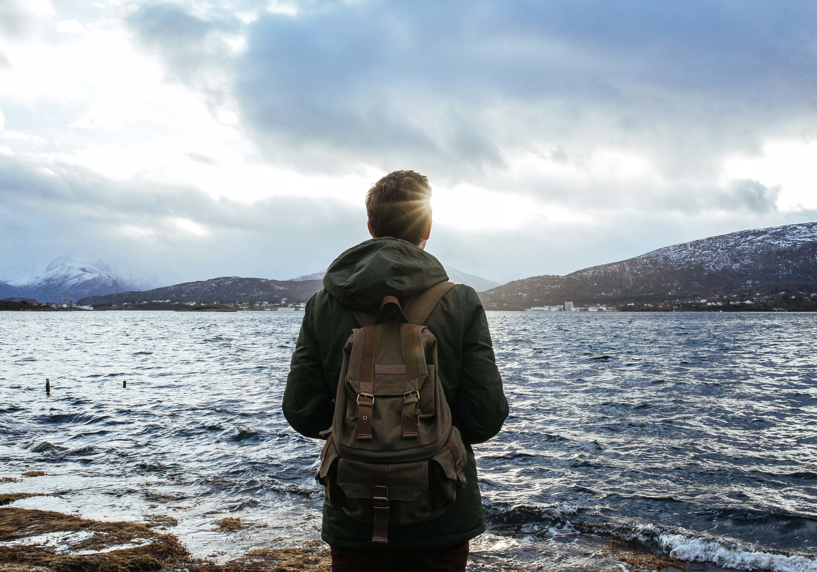 Backpacker Hiker in front of water.